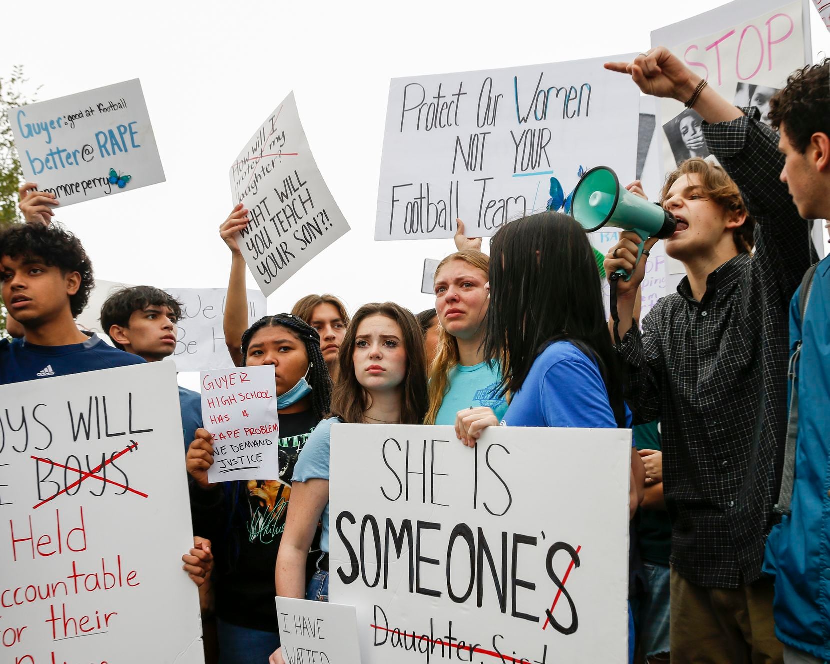 Guyer High School students raise signs and chant during a walkout and protest outside Guyer...