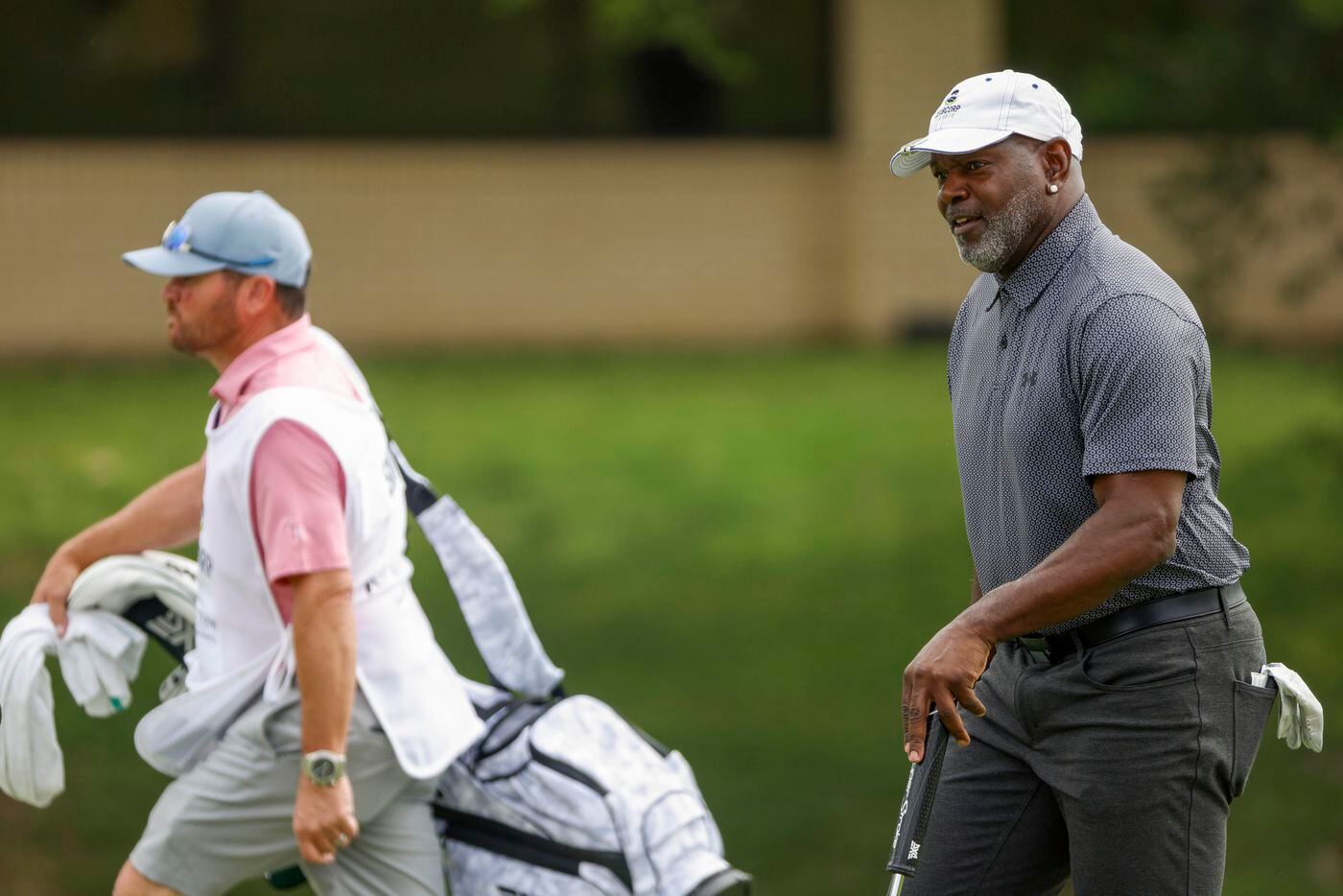 Former Dallas Cowboys player Emmitt Smith walks to the ninth green during the first round of...