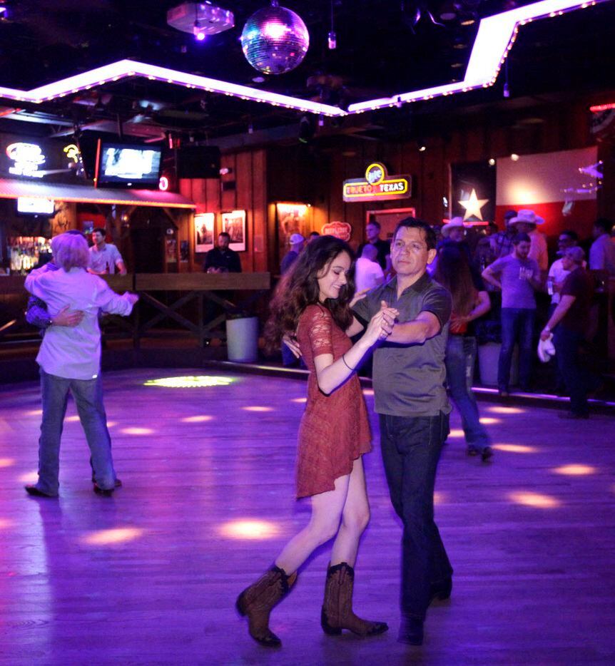 Guests dance and drink at the Round-Up Saloon 