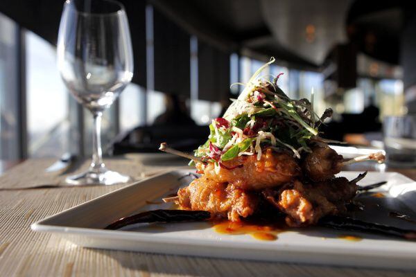 Five Sixty's crispy quail is set on a fruity chile-soy sauce and topped with a lively Asian...