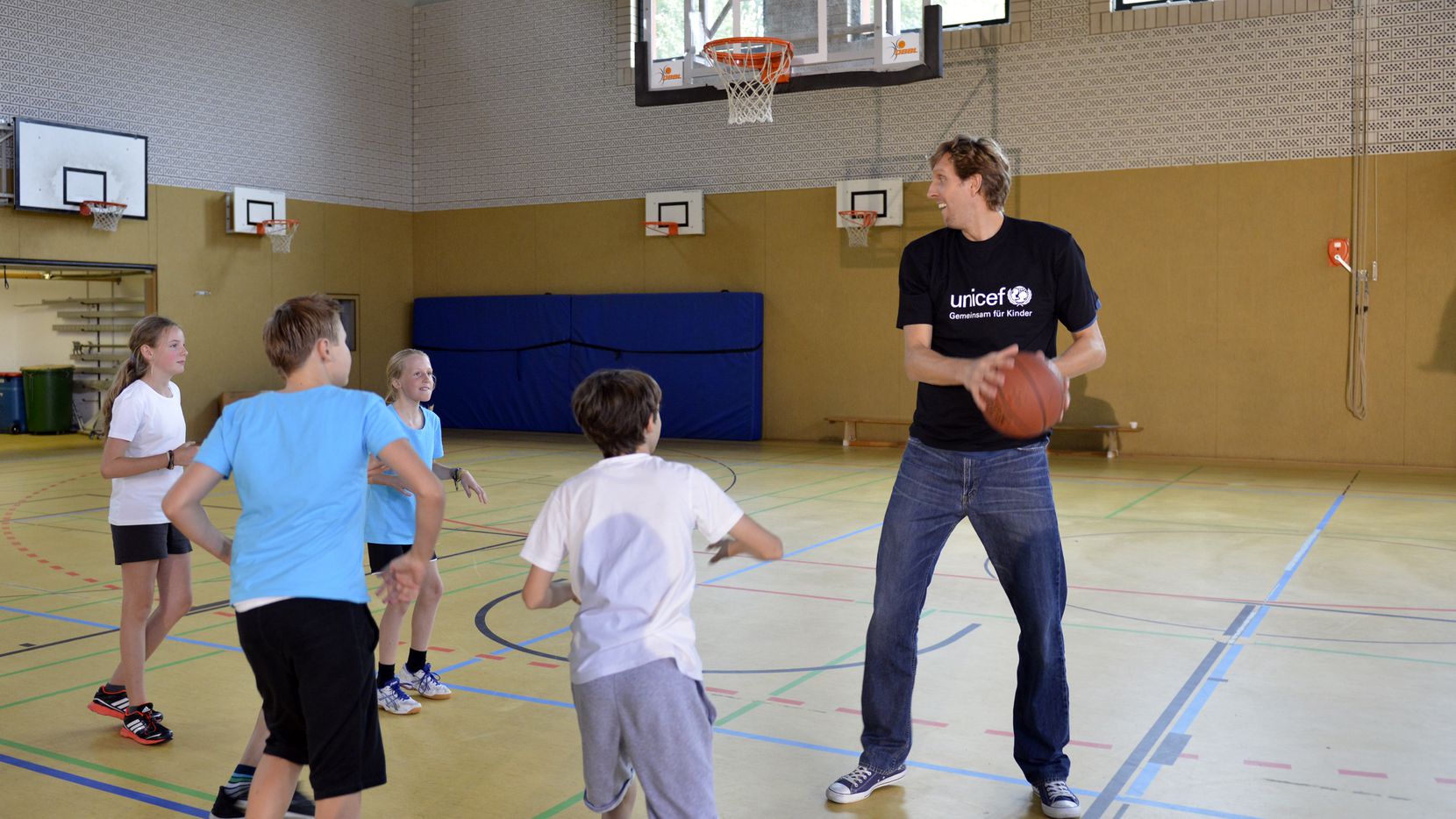 Dirk Nowitzki, playing basketball here with a group of children, will receive the Spirit of...