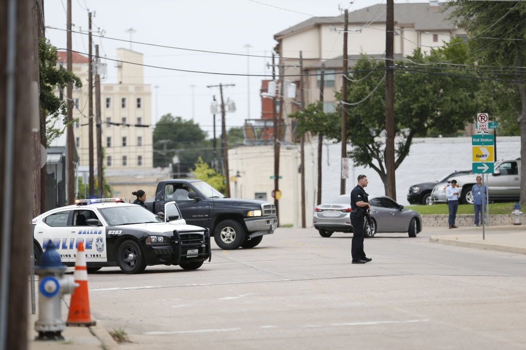 Dallas Police stand guard along Belleview Street near Dallas Police Headquarters in Dallas...