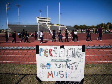 Burnet, Cigarroa and Pershing elementary school students play on the track and football...