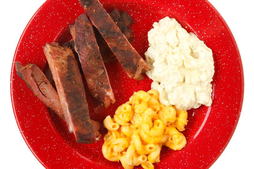 Ribs, potato salad, macaroni and cheese served at Dickey's Barbecue Pit. 