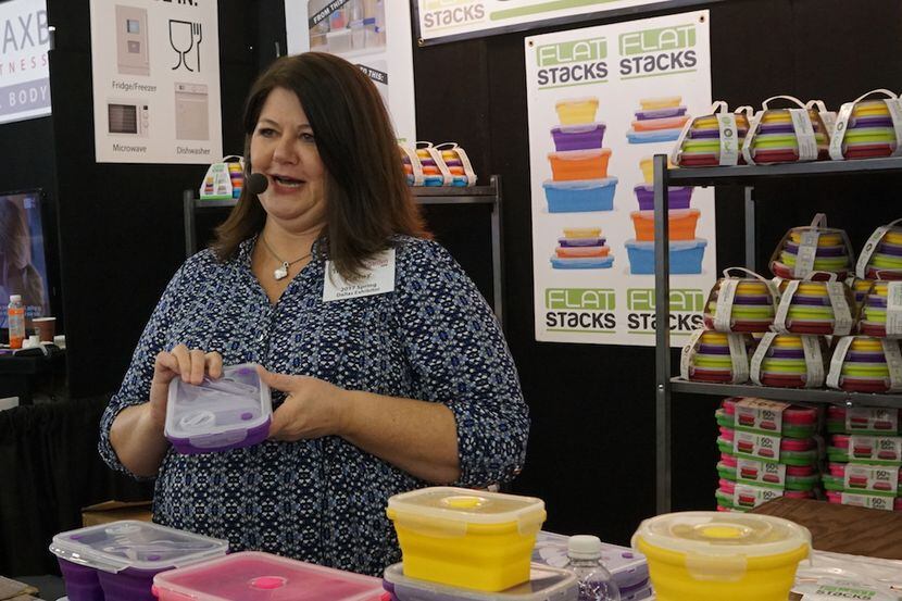 A vendor shows her products at the Home and Garden Show at Dallas Market Hall.