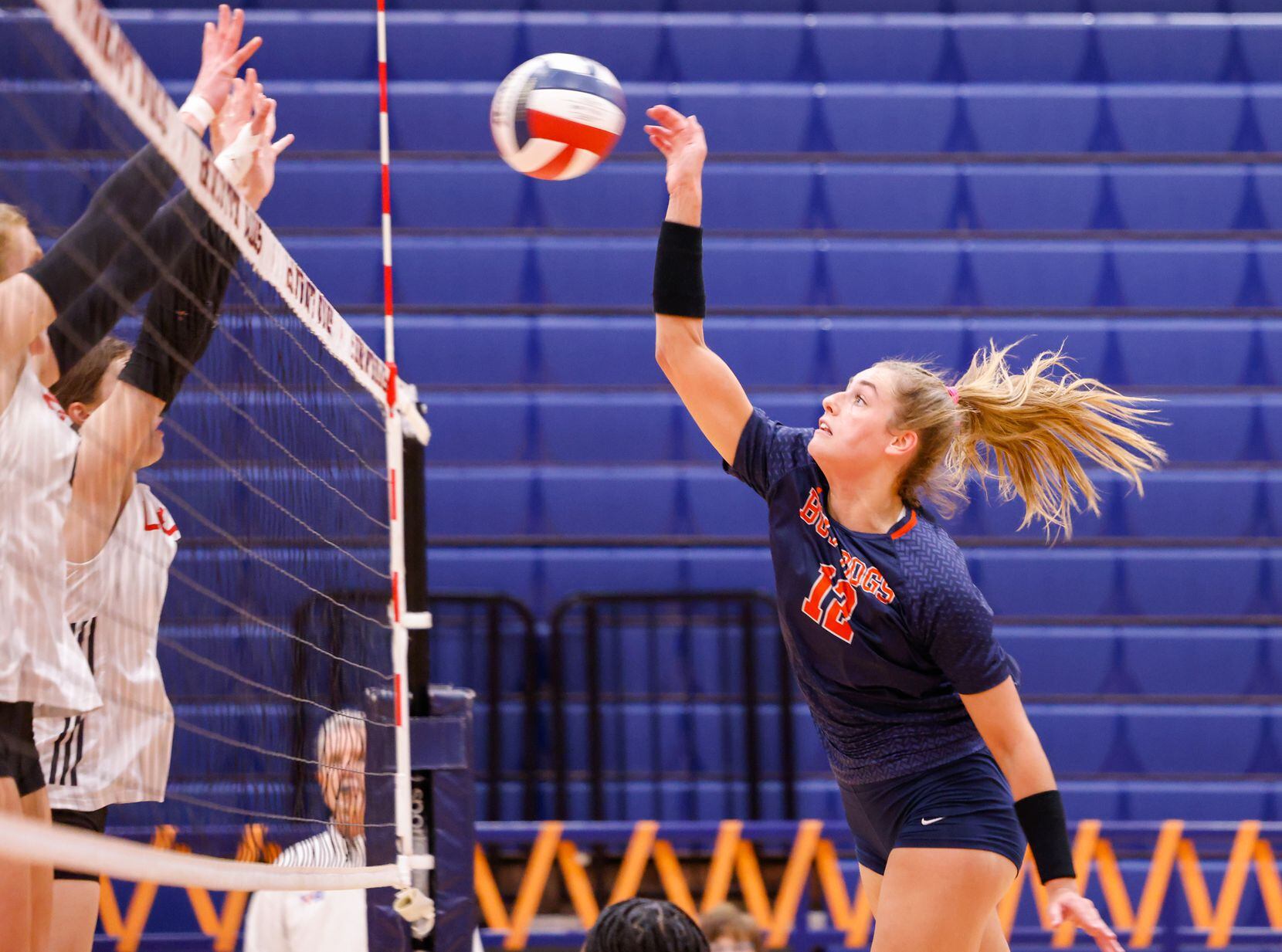 McKinney North Lily Nicholson (12) spikes the ball at a match against Lovejoy in McKinney on...