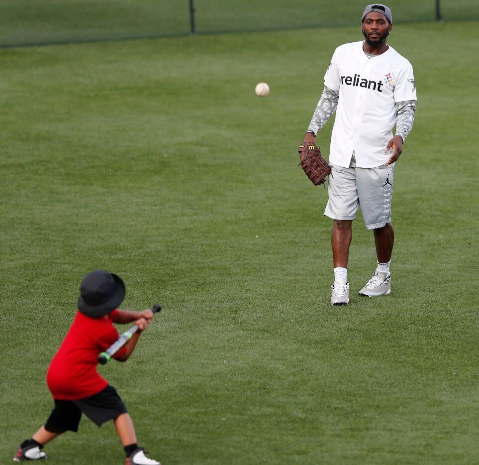 Dallas Cowboys wide receiver Dez Bryant (88) plays baseball with his son after the sixth...