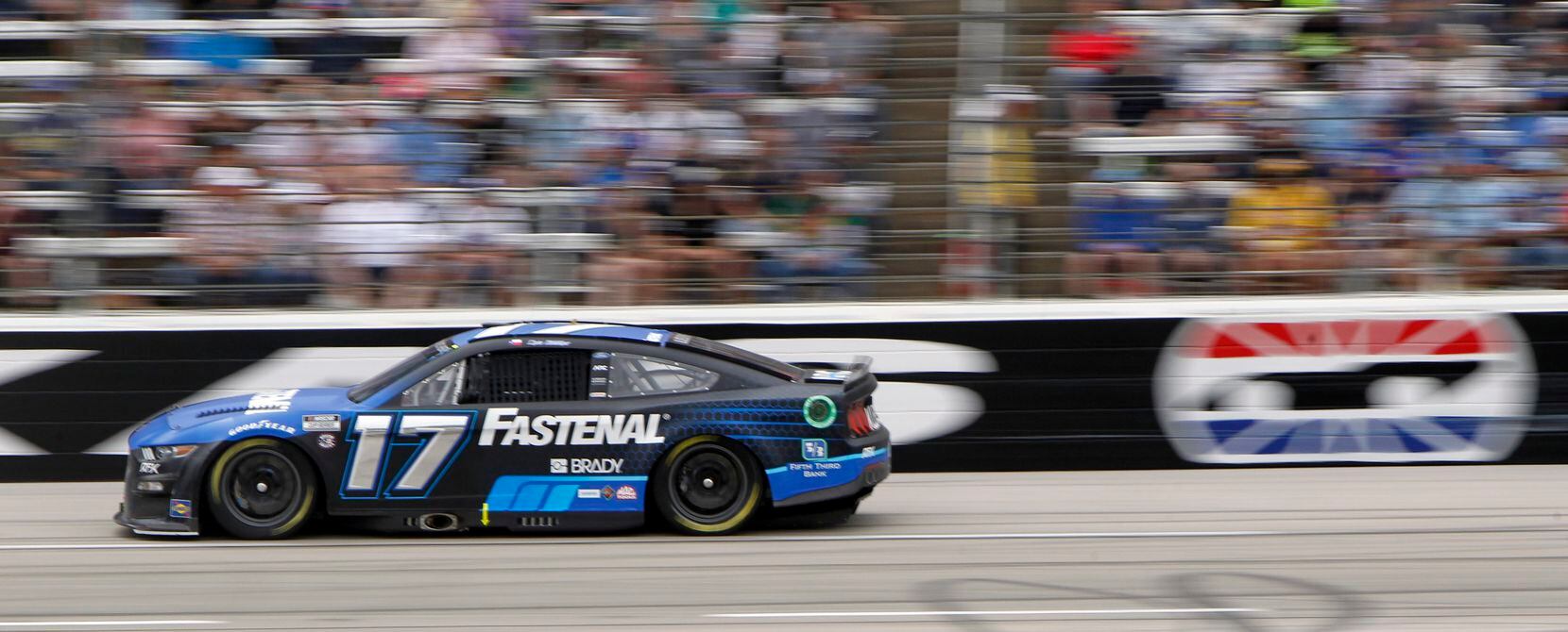 Driver Chris Buescher speeds his way around the track in the #17 Fastenal Ford car during...