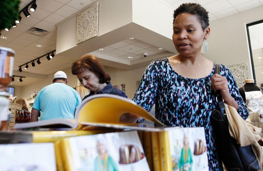 Kristal Ford of Plano looking at a Paula Deen book in the retail shop inside Paula Deen's...