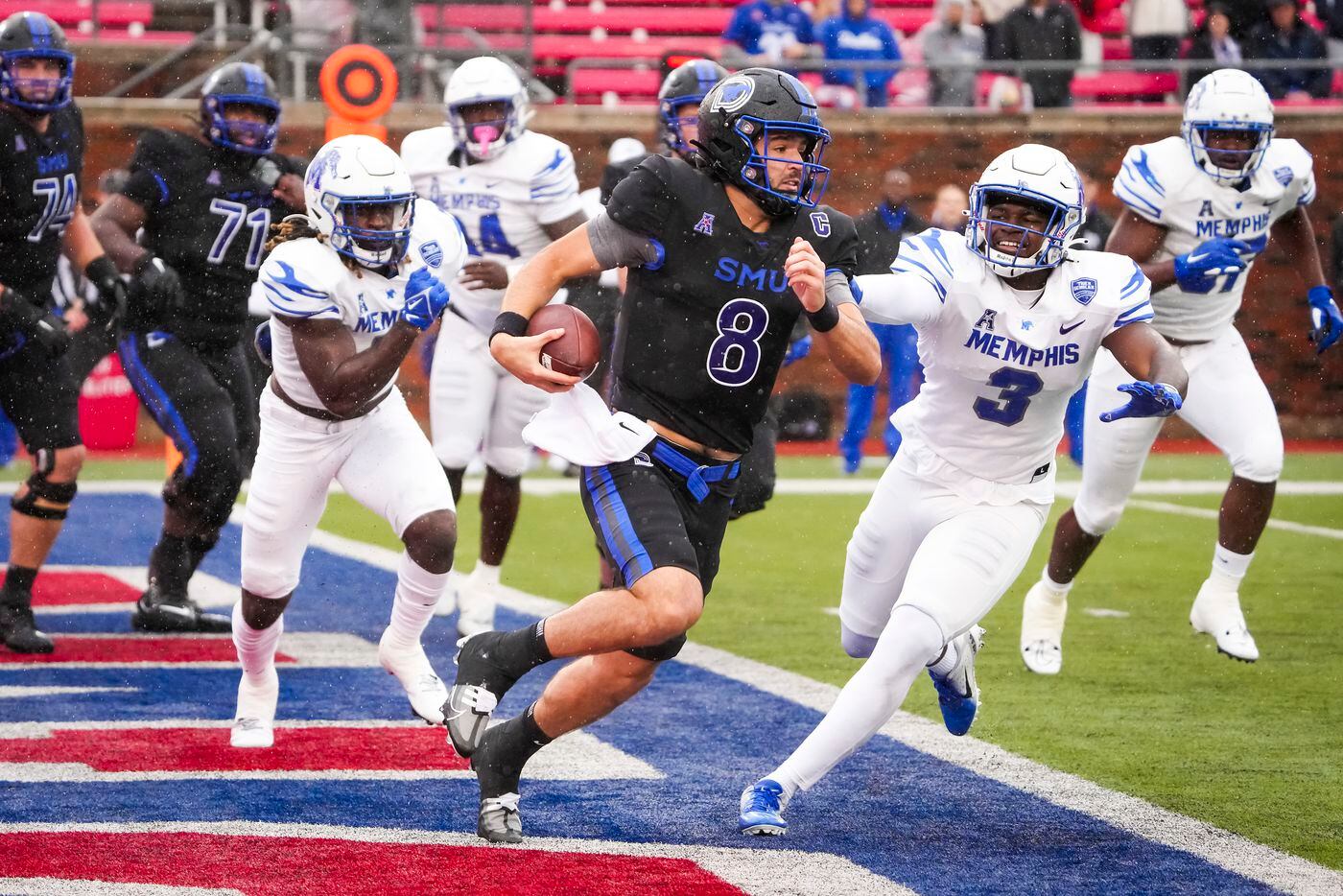 SMU quarterback Tanner Mordecai (8) scrambles from his own end zone to avoid Memphis...