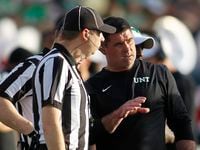 North Texas head coach Seth Littrell, right, converses with a pair of game officials...