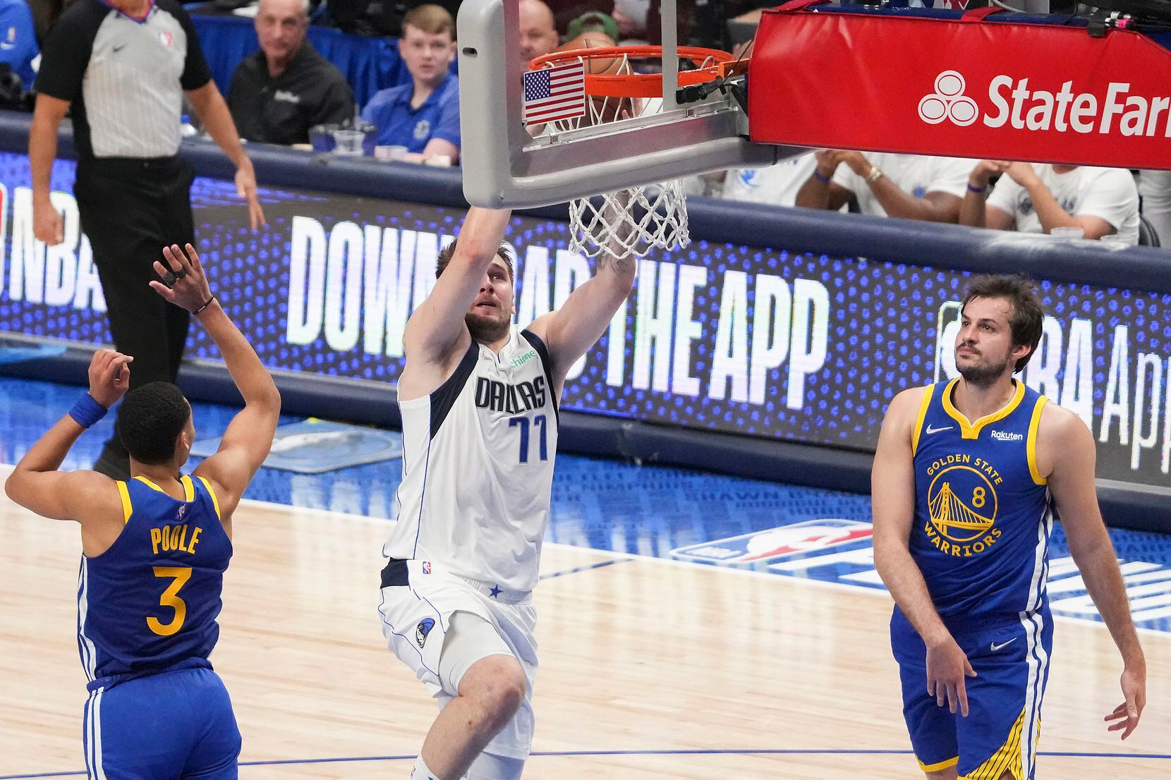 Dallas Mavericks guard Luka Doncic (77) dunks the ball past Golden State Warriors guard...