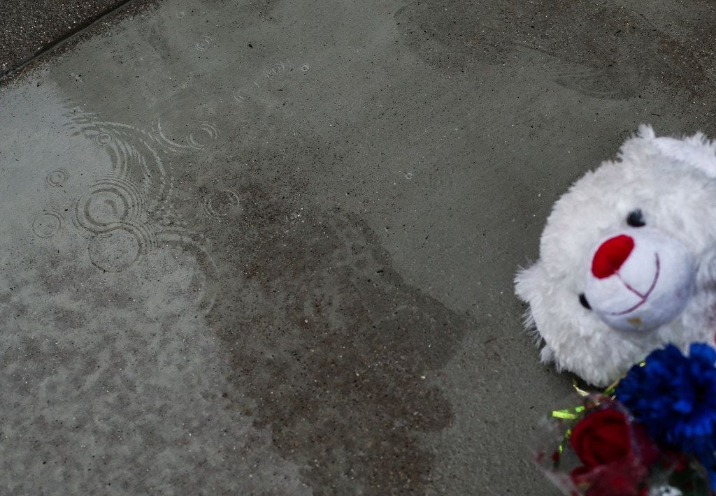 Rain falls at a memorial near where 13-year-old Malik Tyler, of Dallas, was killed after...