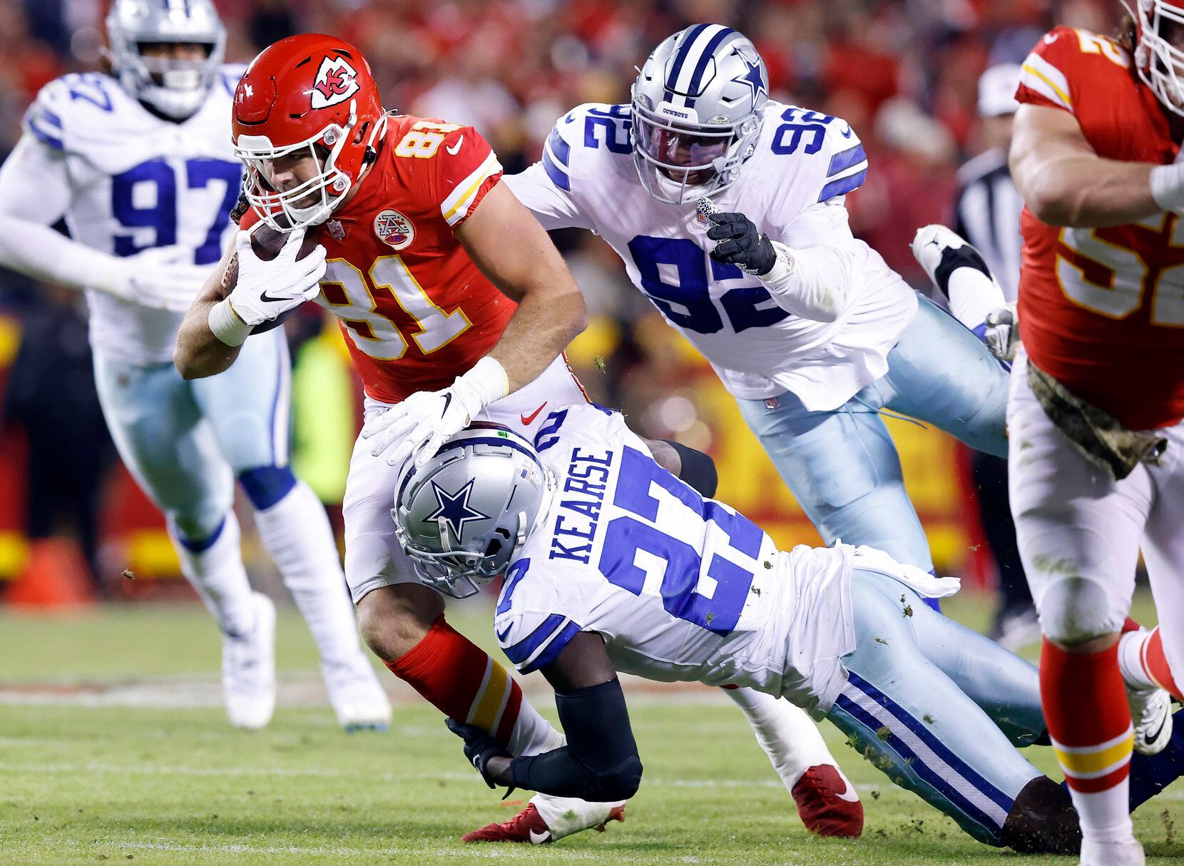 Dallas Cowboys defensive end Dorance Armstrong (92) and safety Jayron Kearse (27) combine for a fourth quarter tackle of Kansas City Chiefs tight end Blake Bell (81) at Arrowhead Stadium in Kansas City, Missouri, November 21, 2021. The Cowboys lost, 19-9. (Tom Fox/The Dallas Morning News)