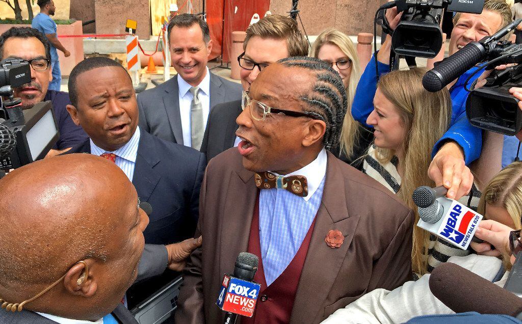 Dallas County Commissioner John Wiley Price talks to the media as he walks out of the the...