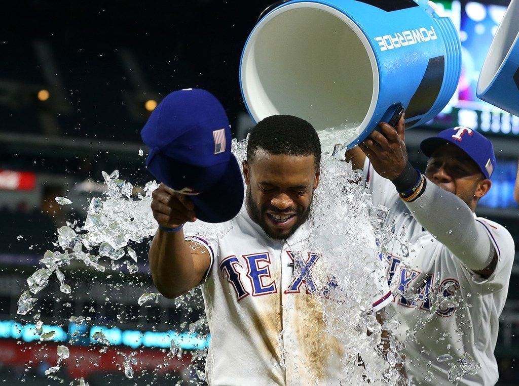 ARLINGTON, TX - SEPTEMBER 11:  Delino DeShields #3 of the Texas Rangers gets showered with...