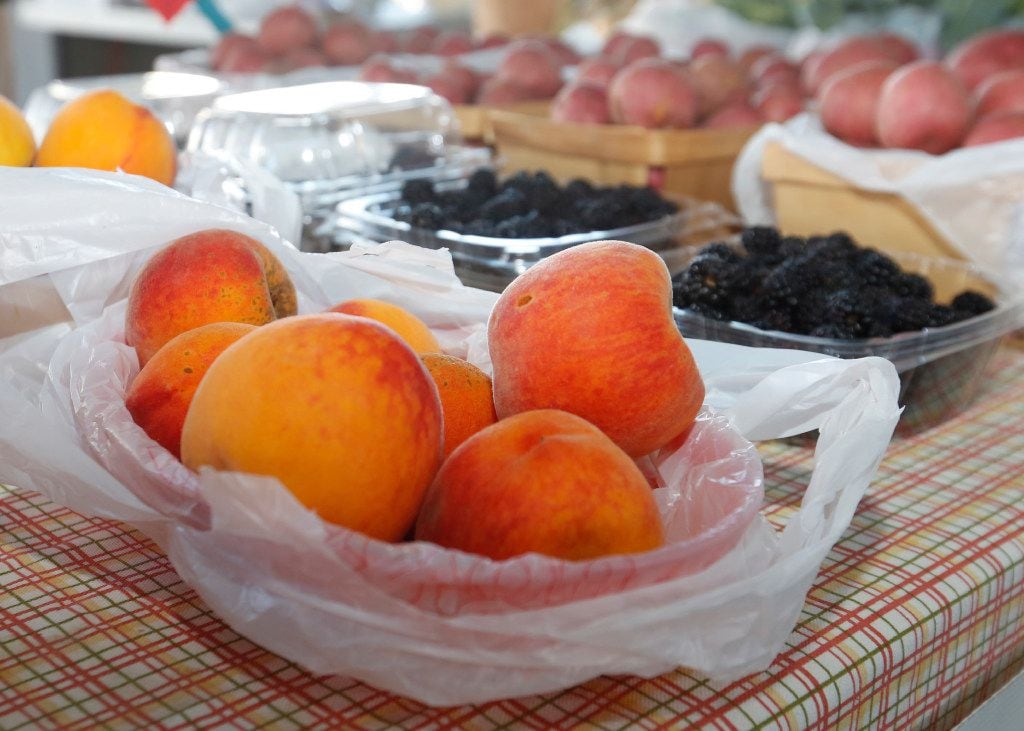 Peaches and other fruits offered at the Williams Farm booth in The Shed at the Dallas...
