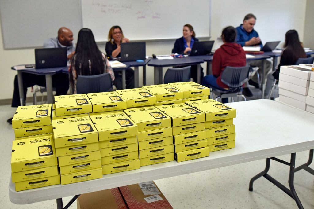Smartphones and tablets are stacked for students involved in the 1Million Project, which...