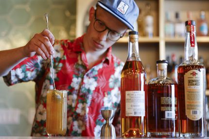 Blake Weaver, head bar manager of Locals Craft Beer & Fine Wine, prepares a cocktail called...