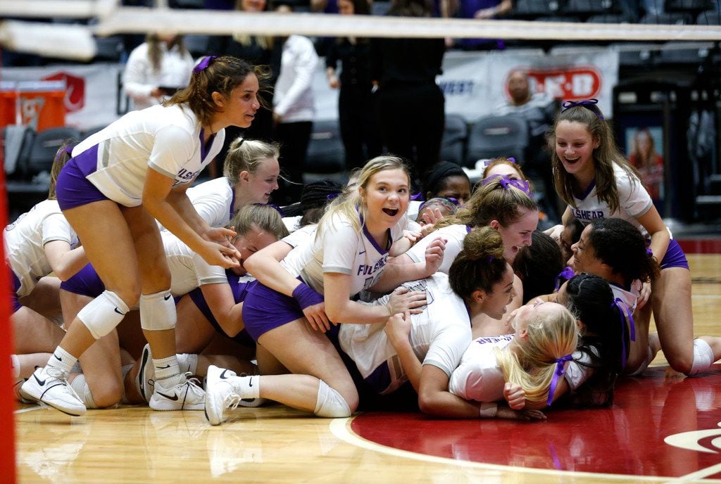 The Lamar Fulshear Chargers dog pile after winning a Class 4A volleyball state semifinal...