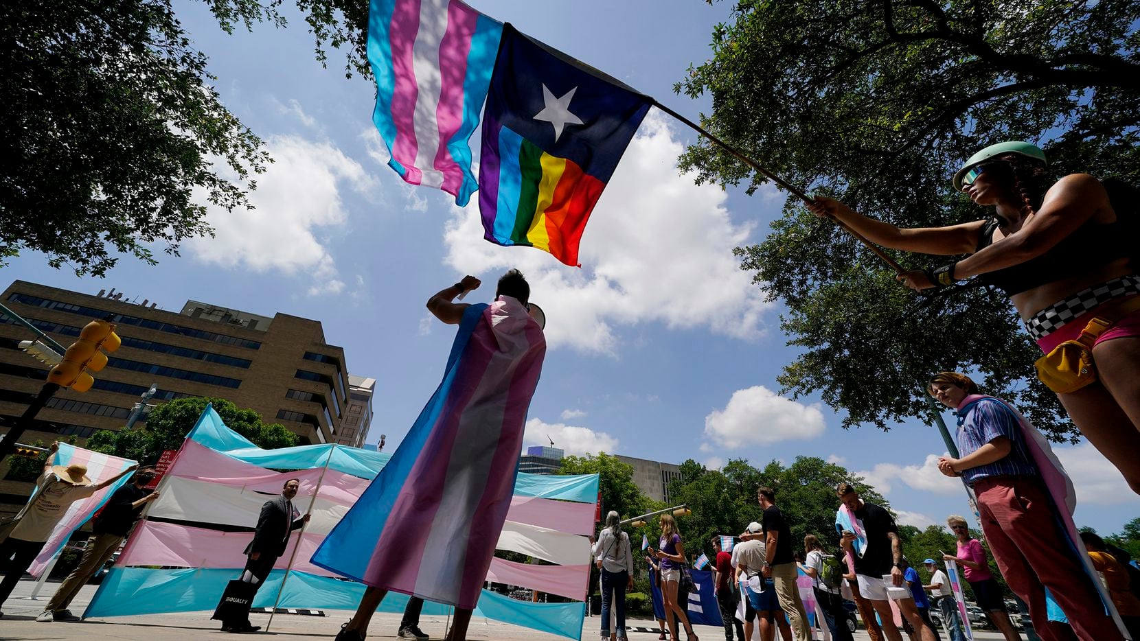 Demonstrators gather on the steps to the Texas Capitol to speak against transgender-related...