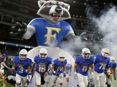 Frisco players run onto the field from their mascot inflatable before the start of their...