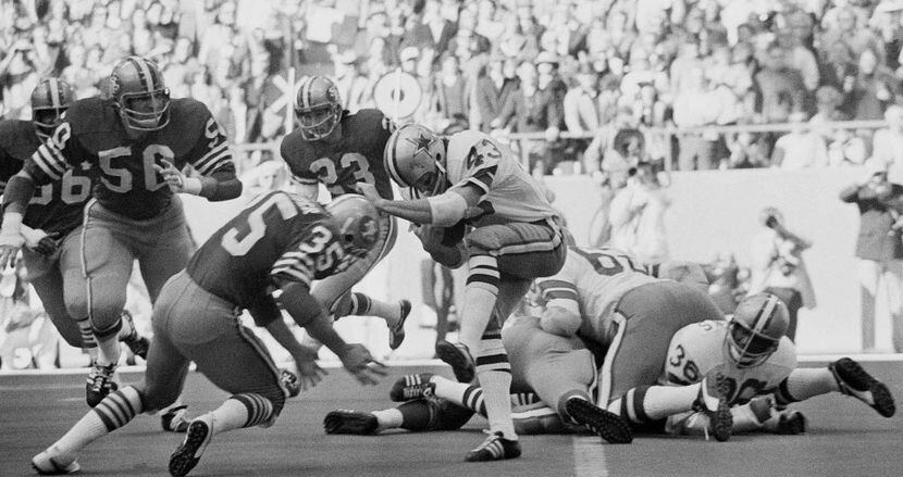 Dallas Cowboys safety Cliff Harris (43) tries to evade a tackle by San Francisco 49ers...