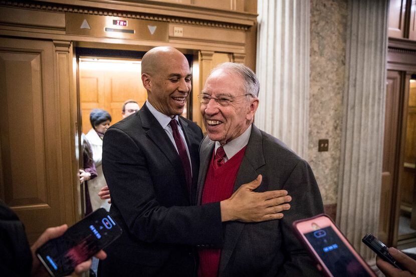 Sens. Cory Booker (D-N.J.) and Chuck Grassley (R-Iowa) embrace after the Senate passed a...