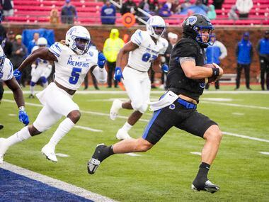 SMU quarterback Tanner Mordecai (8) scrambles from his own end zone to avoid Memphis...