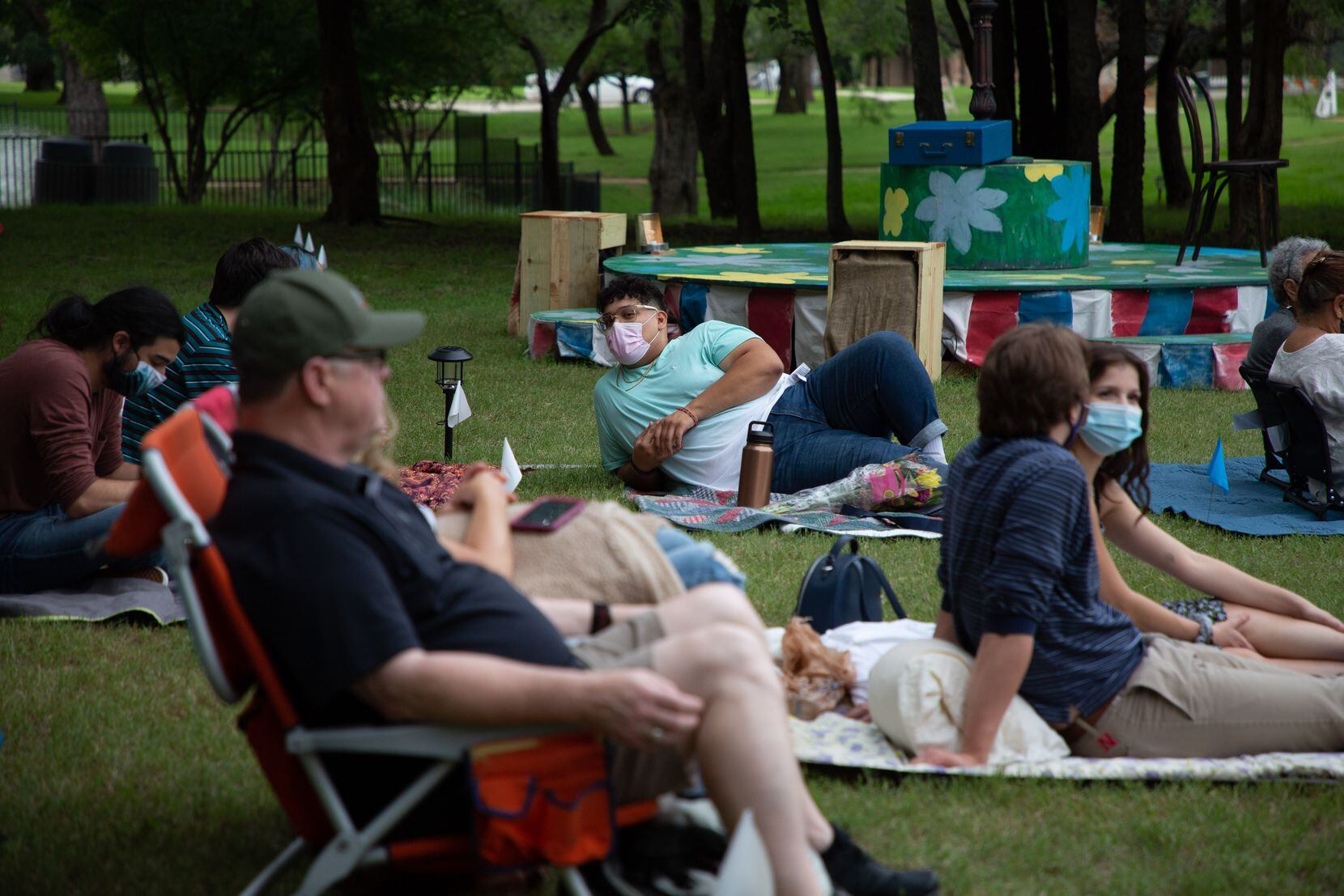 People sit among the makeshift set outside of the Coppell Senior and Community Center, as they await the final dress rehearsal of "Music Man," on June 2.