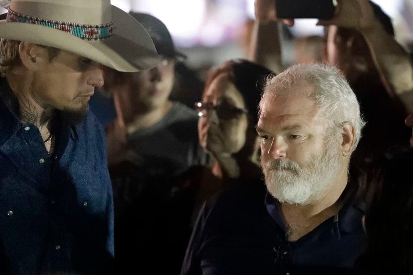 Stephen Willeford, right and Johnnie Langendorff, left, attend a vigil for the victims of...