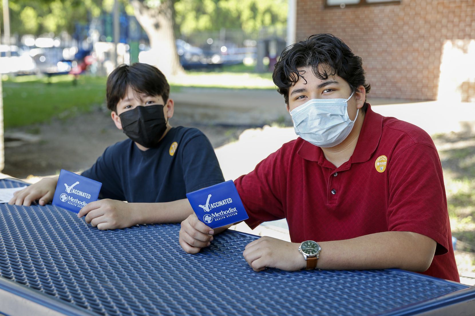 Giovany Aguado, 16, (right) pictured with his brother Joncarlo Aguado, 13, after receiving their first dose of the Pfizer COVID-19 vaccine at a vaccination clinic at St. Pius X Catholic Church on Saturday, June 19, 2021, in Dallas. 