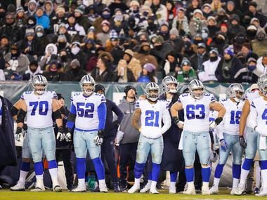 Dallas Cowboys starters, including, guard Zack Martin (70), guard Connor Williams (52), running back Ezekiel Elliott (21), center Tyler Biadasz (63), wide receiver Amari Cooper (19) and quarterback Dak Prescott (4) wait to go into the game during the second half of an NFL football game against the Philadelphia Eagles at Lincoln Financial Field on Saturday, Jan. 8, 2022.