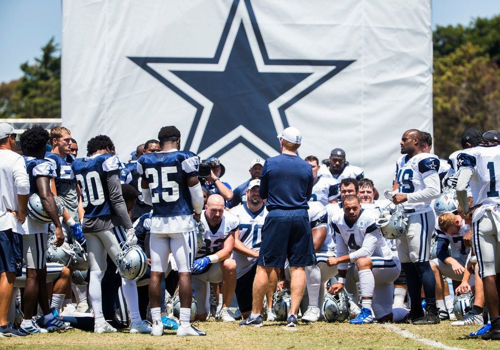 Dallas Cowboys head coach Jason Garrett talks with his team during a morning practice at...