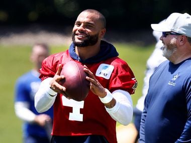 Dallas Cowboys head coach Mike McCarthy and  quarterback Dak Prescott (4) laugh following Training Camp practice at The Star in Frisco, Texas, Wednesday, August 25, 2021.