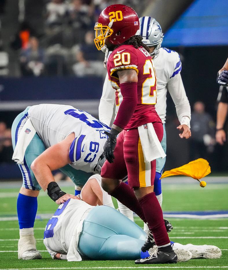 Washington Football Team cornerback Bobby McCain (20) tosses away the penalty flag thown for his hit on Dallas Cowboys tight end Dalton Schultz (86) on a 4th down play during the first half of an NFL football game at AT&T Stadium on Sunday, Dec. 26, 2021, in Arlington.