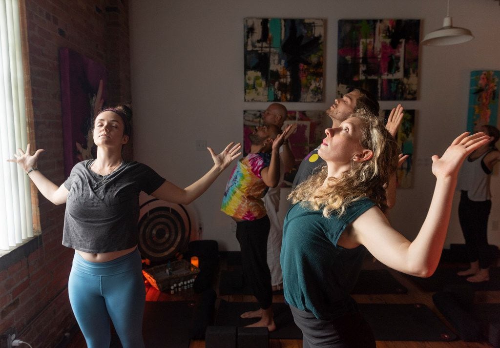 Leigha McCathren (left) leads a stretching and meditation class at Refuge Meditation for...