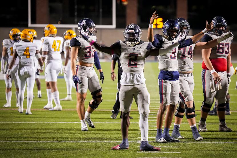 Allen running back Kayvion Sibley (2) and quarterback Mike Hawkins (3) celebrate as the...