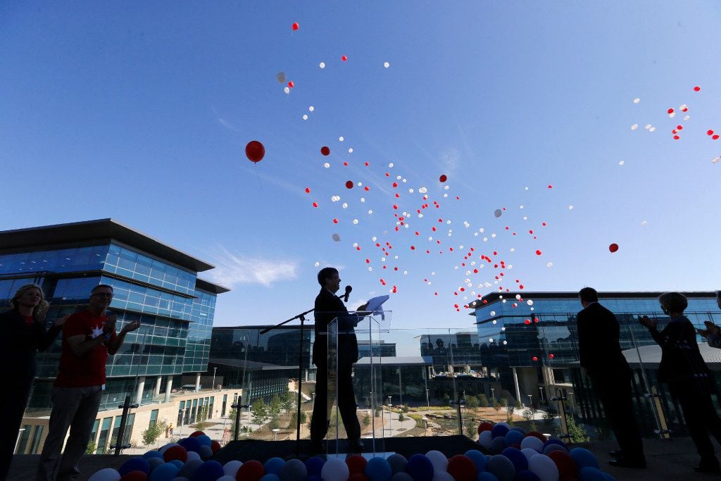 Jim Lentz, CEO of Toyota Motor North America watches balloons float away during a brief...