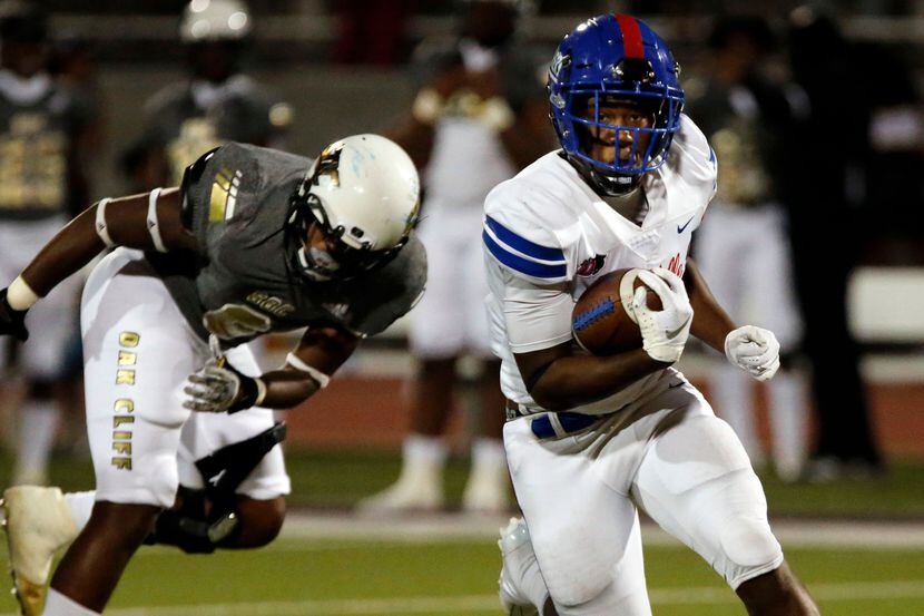 Duncanville’s Malachi Medlock (5) eludes South Oak Cliff’s Adul Muhammad (6) and gains a...