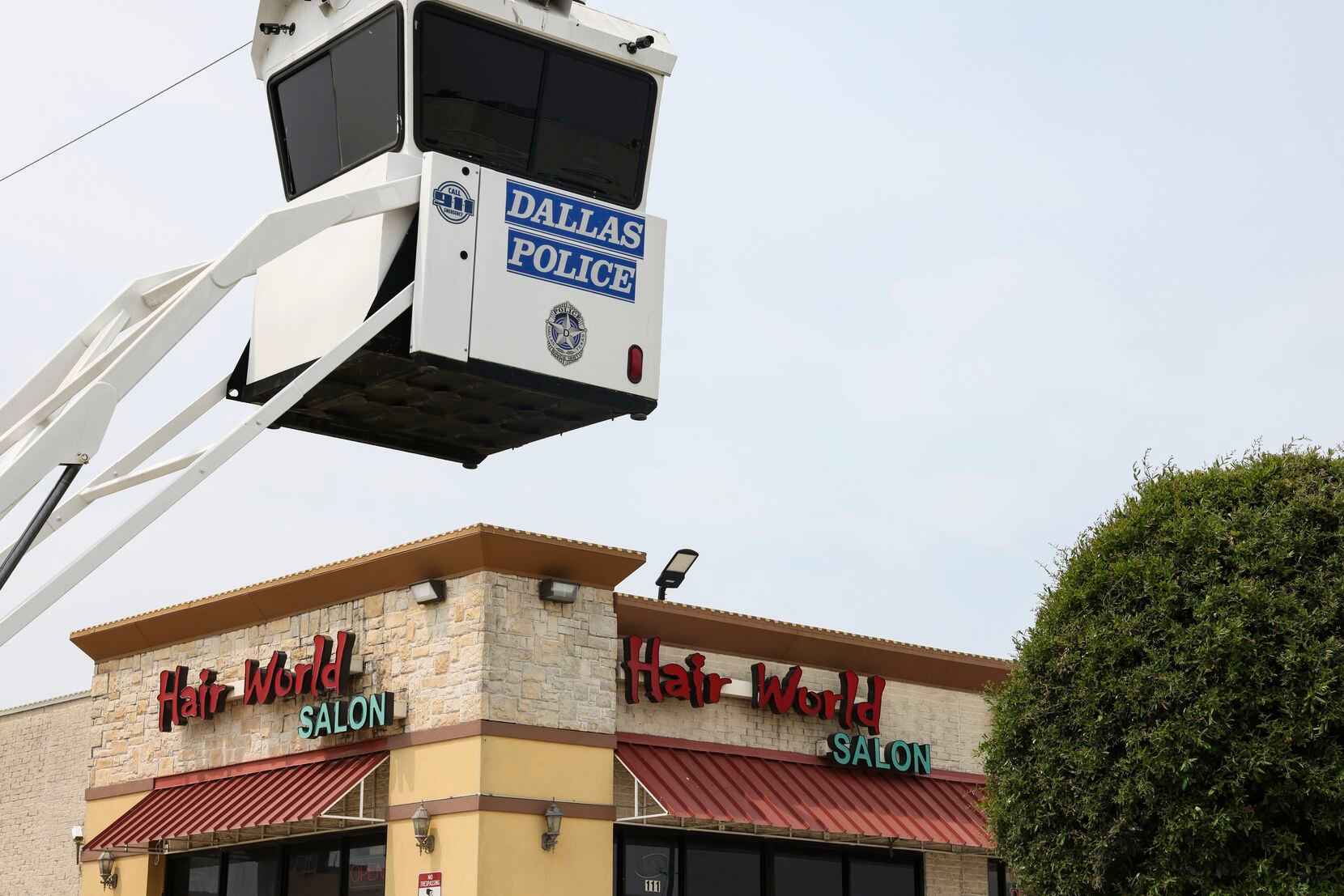 A Dallas Police Surveillance  stand overlooks the parking lot of Hair World Salon on...