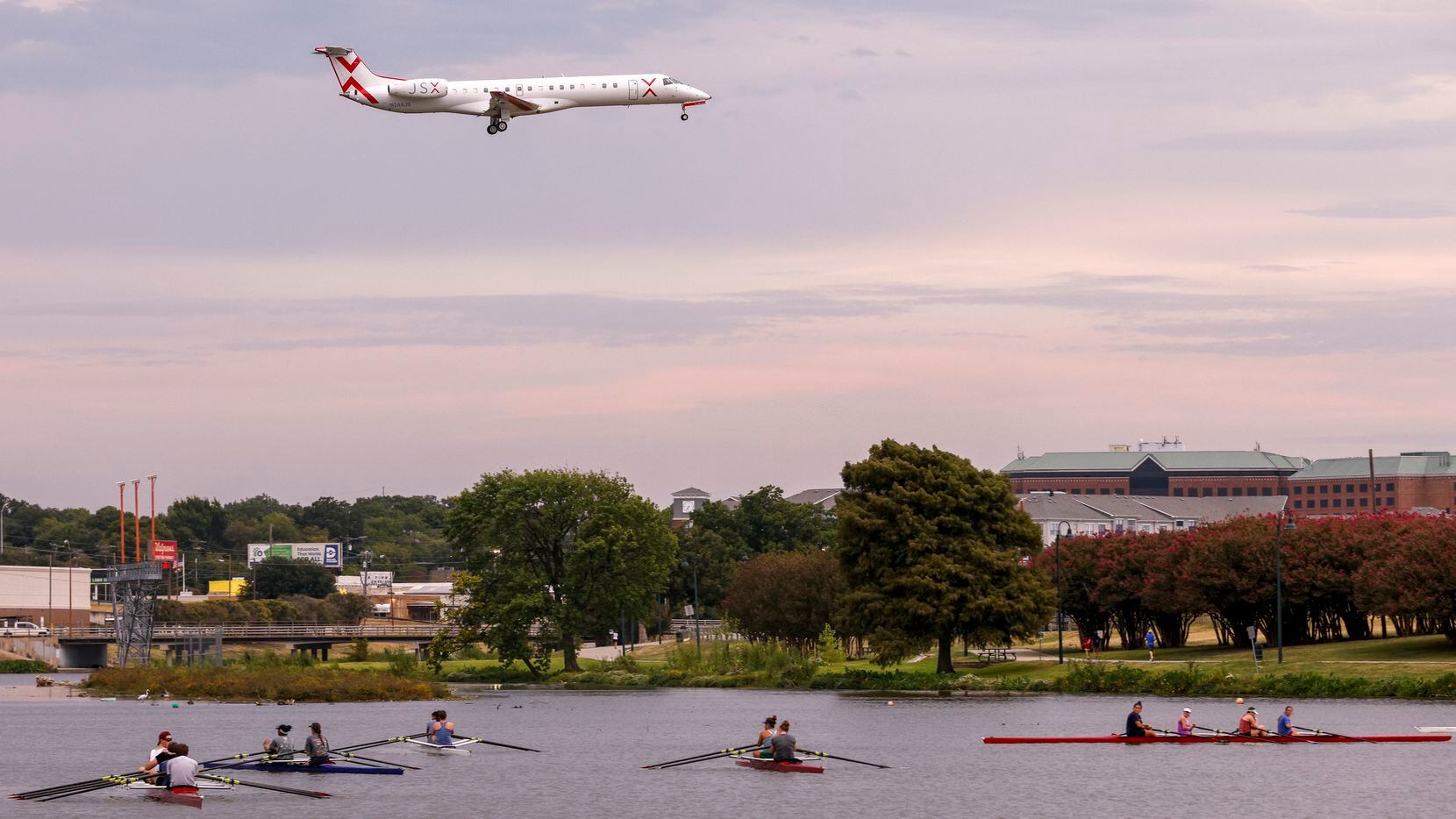 A jet flies over Bachman Lake as it prepares to land at Dallas Love Field airport on Tuesday, Sept. 28, 2021, in Dallas. Ford could potentially choose to locate a new $160 million autonomous vehicle facility in Love Field neighborhood.
