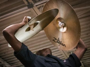 Darrquon Threlkeld, 18, practices the cymbals with  the Dallas Mass Band at the Braswell...