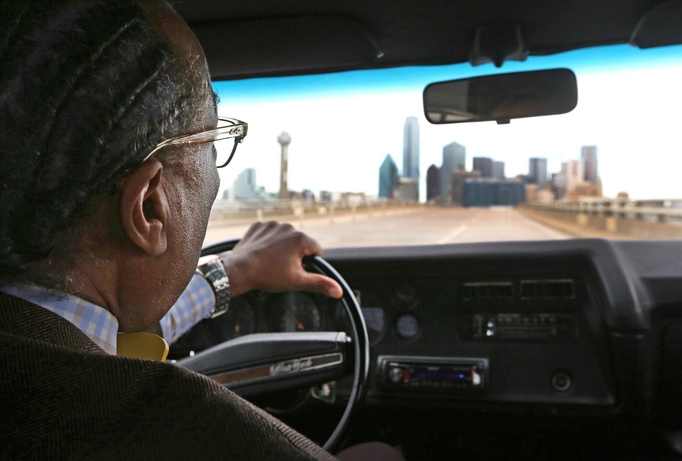 Dallas County Commissioner John Wiley Price drives back to downtown Dallas in one of his...