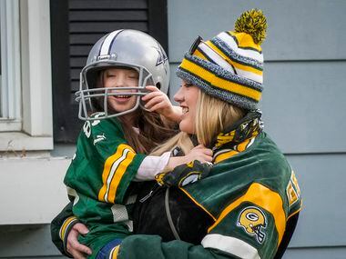 Skyler Jenswold, 4, wears a Dallas Cowboys helmet while decked out in Green Bay Packers gear...