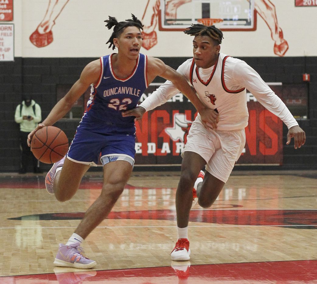 Duncanville guard Davion Sykes (22), left, drives against the defense of Cedar Hill's Savon Price (0) during first half action. The two teams played their District 11-6A boys basketball game at Cedar Hill High School in Cedar Hill on January 14, 2022. (Steve Hamm/ Special Contributor)