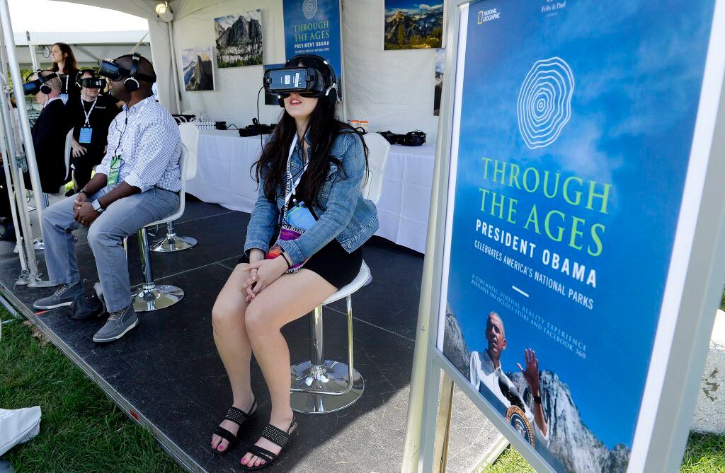 A women experiences a virtual reality project, "Through the Ages: President Obama Celebrates...