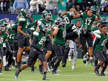 Waxahachie high players run onto the field after winning a high school football game over...