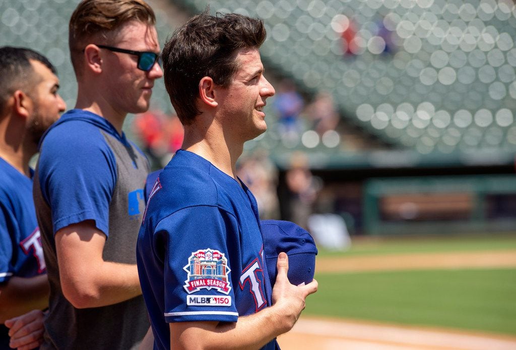 Texas Rangers' Nick Solak, in his major league debut, stands on the field for the playing of...