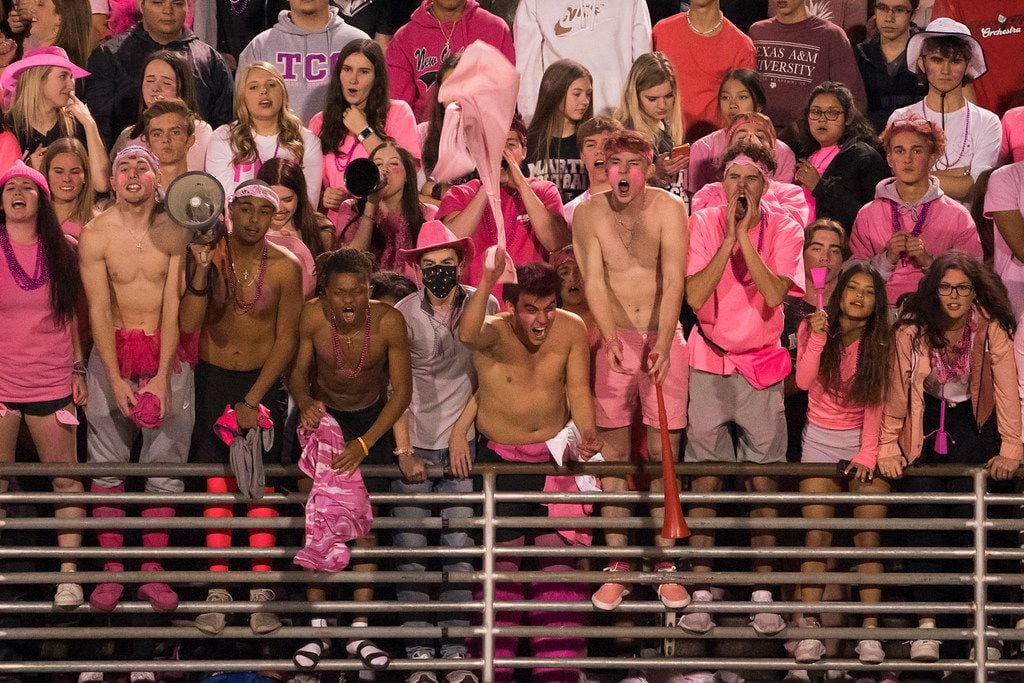 Arlington Martin fans cheer their team during the second half of a high school football game...